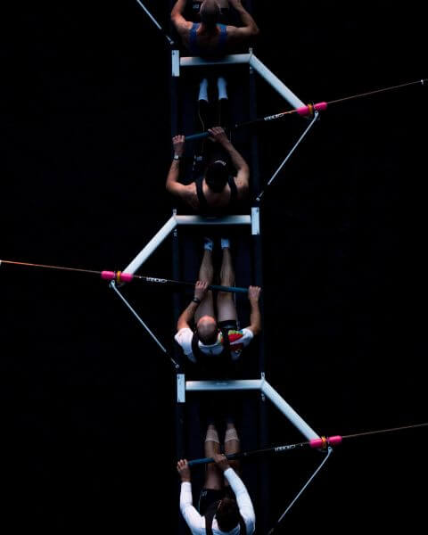 birds eye view of rowing team against black background