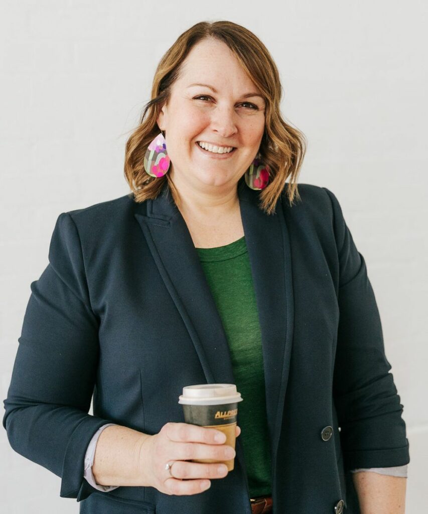 lorissa smiling while holding coffee