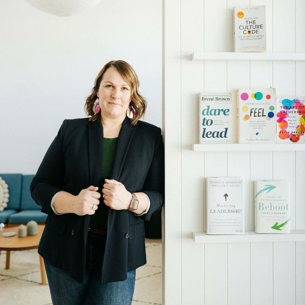 Lorissa Garcia standing next to emotional culture books.